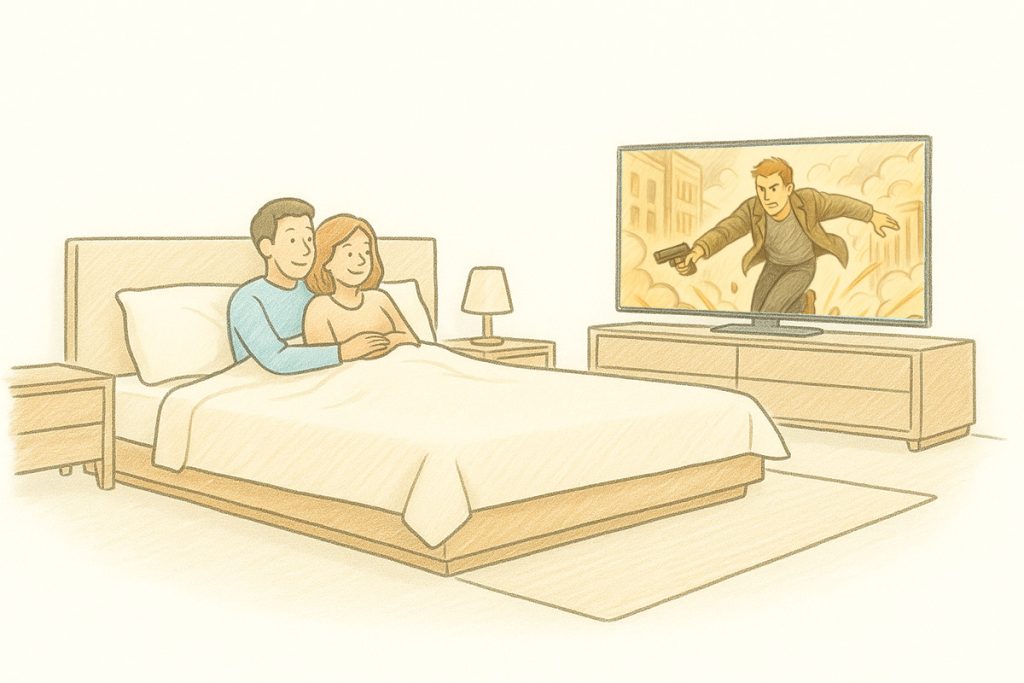 Coppia a letto che guarda un film